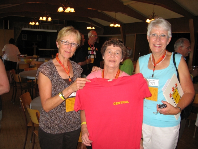 Nora Bowler (Christensen), Bev Pomrenke (Bregg) and Faye Little (Rudland) hold up donated CCI shirt 